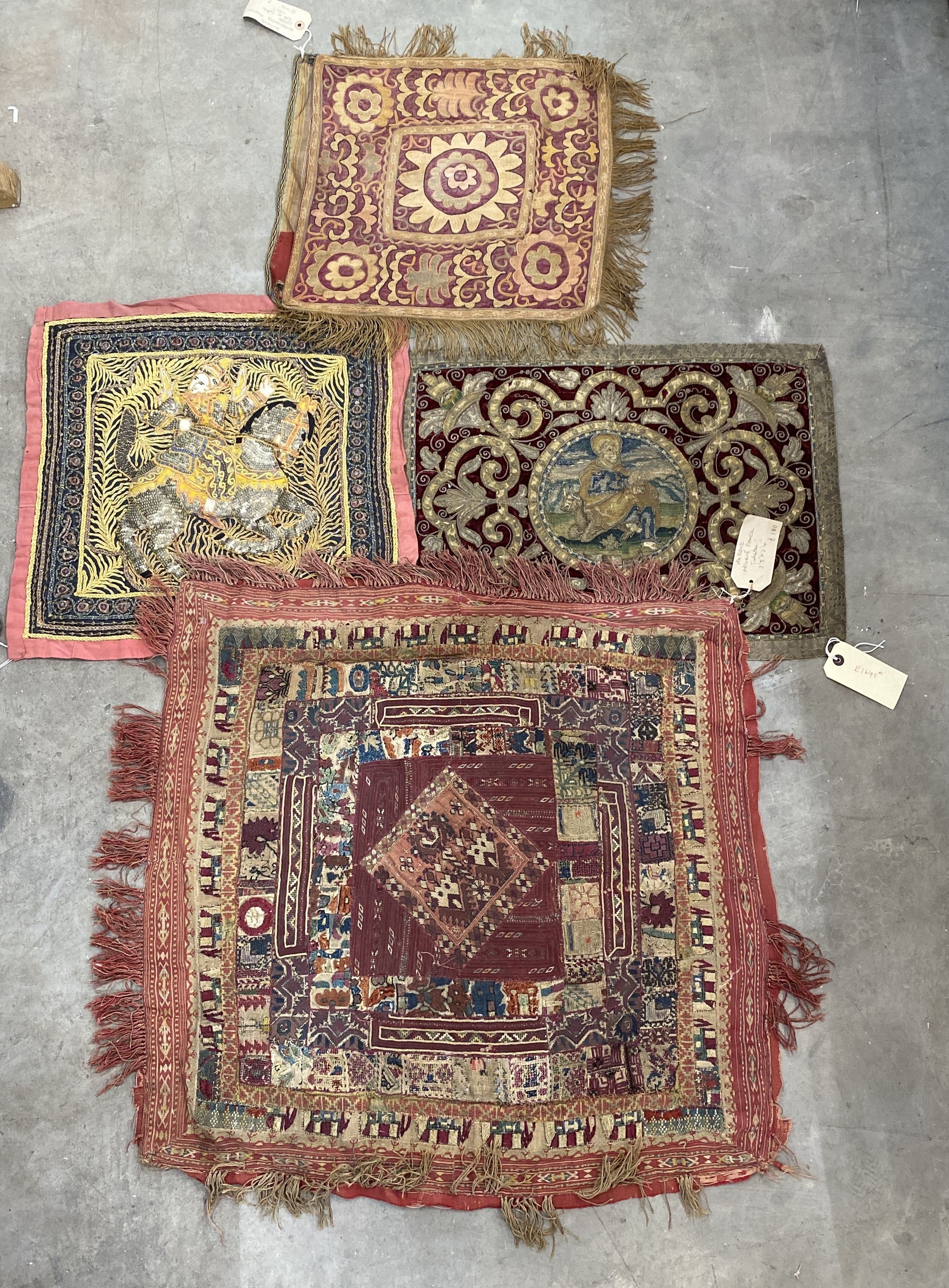 An Indian appliqué panel, two Indian appliqué covers and one other.